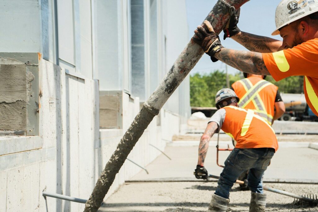 a group of construction workers working on a building
