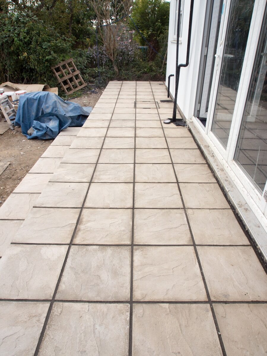 Newly installed paving stones outside a building.