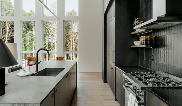 a kitchen with a stove top oven next to a window